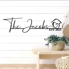 the jacks test wall decal is shown in black on a wooden table next to a potted plant