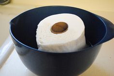 two rolls of toilet paper in a blue bowl