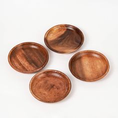 three wooden bowls sitting on top of each other