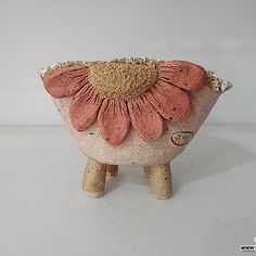 a ceramic flower pot sitting on top of a white table