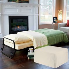 a bed sitting on top of a hard wood floor next to a fire place in a living room