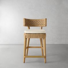 a wooden chair with a white cushion on it's seat and back rests against a gray wall