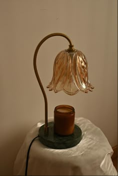 a table lamp sitting on top of a white cloth