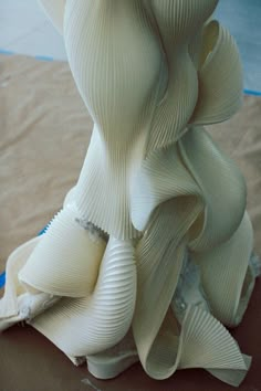 the sculpture is made out of white paper