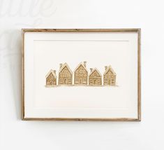 three framed houses are on display in a wooden frame, with the word little above them