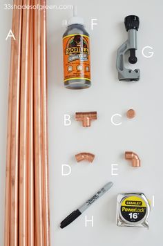 copper pipes, glue, and other tools are laid out on a white surface