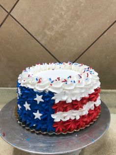 a cake with red, white and blue icing on it sitting on a table