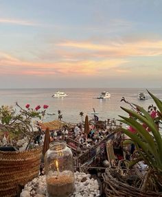 there are many baskets and plants on the beach