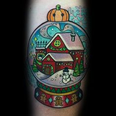 a snow globe with a house in it and a snowman on the roof inside