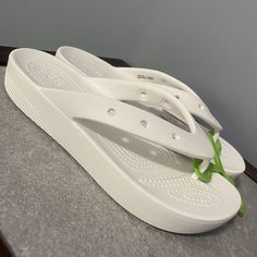 Elevate Your Summer Footwear Collection With These Brand New Crocs Classic Platform Flip Flop Sandals. The White Synthetic Upper Of These Sandals Features A Strap With The Crocs Logo Accent, Making Them Perfect For Beach Days, Showers, And Casual Wear. Slip Them On And Enjoy The Comfort Of The Cushioned Insole, Lightweight Outsole, And Low Block Heel Design. These Sandals Are Also Water Friendly, Making Them Ideal For Travel And Outdoor Activities. Available In Women's Size 9, These Sandals Have Casual Flip Flops, White Croc Sandals, Crocs Sandals Woman Flip Flops, Trendy White Slip-on Flip Flops, Non-slip White Beach Sandals, Crocs Logo, White Non-slip Flip Flops For The Beach, New Crocs, White Flip Flops