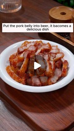 a white plate topped with bacon on top of a wooden table