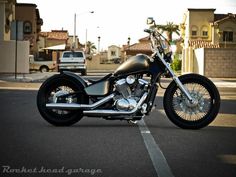 a black motorcycle parked in the middle of a street