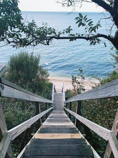 the stairs lead down to the beach from the water's edge are made of wooden planks