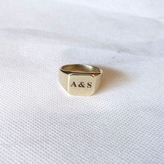 About item Item :- Custom Signet engraving Ring Ring size :- Chose from variation (Custom size accepted) Material  :- Sterling Silver or Brass (Choose from Variation) Title:-Square Signet Ring in 14k Solid Gold ring, Custom Pinky Signet Ring for Men and Women's, Engraved Family Ring, Personalized Graduation Gift, Initial signet ring, Engraving ring, Valentine's day gift, Promise ring, Couples ring Description:- We accept all types of custom & personalized order. Please send us a message if you are interested in a custom creation. ♥ Is brass harmful for skin? As such, if you're wearing a brass ring, it is most likely to leave a green mark on your skin when you sweat or wash your hands. This is generally not harmful or painful (it is just oxidation of the metal) and will go away within a few Signet Ring Engraving, Signet Ring For Men, Engraving Ring, Ring Engraving, Pinky Signet Ring, Ring Initial, Family Ring, Couples Ring, Family Rings