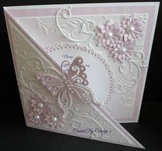 a close up of a greeting card with flowers and butterflies on it's side