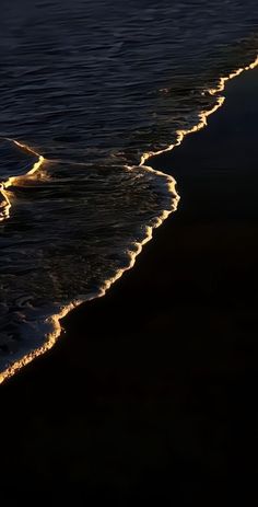 the waves are coming in to shore at night