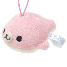 a pink stuffed animal with a tag hanging from it's side