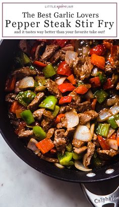 a skillet filled with meat and vegetables on top of a white counter next to a spatula