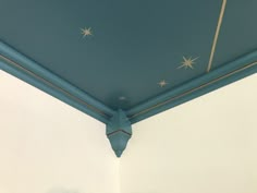 the ceiling is painted blue and has stars on it