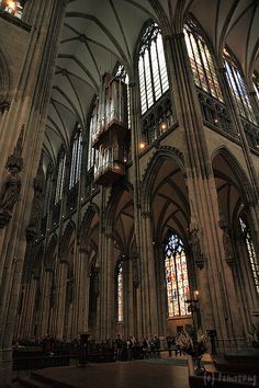 the inside of a large cathedral with stained glass windows