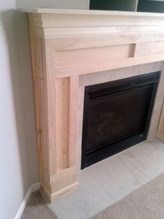 an empty fireplace in a room with white walls