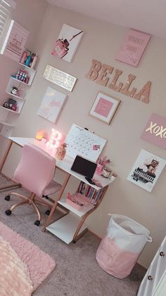 a bedroom with pink decor and pictures on the wall, including a desk and chair