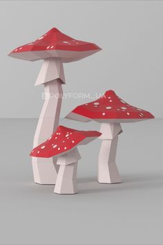 three red mushrooms with white spots on them are standing in the middle of a gray background