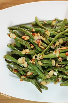 green beans and almonds on a white plate