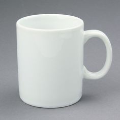 a white coffee cup sitting on top of a table