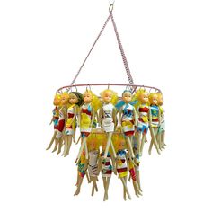 a group of dolls hanging from a chain