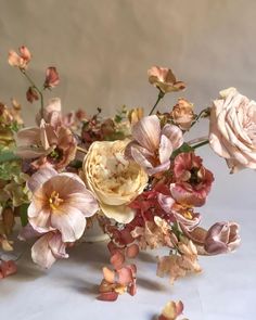 a bunch of flowers that are sitting on a table