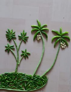 some green plants with white flowers and leaves on them are arranged in the shape of a boat