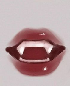 a close up view of a red lip on a white surface