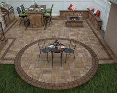 a patio with chairs, table and grill in the middle of it's back yard