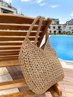 A beautiful and unique handmade bag available in two sizes.This stylish bag is made with high quality paper yarn.It can be used both daily or at the beach.It is also a great gift for any occasion. Product details: -It is crochet. -It is not lined and has not pockets. -Not washable,not dry clean.It can be wiped with a damp cloth. -Delivery time may vary between 20-25 days. -We make it according to the order. -Made in Türkiye. Material:Paper Yarn Dimensions:           Large 58x45 cm./22,83x17,71 inc.           Small 55x36 cm./21,65x14,17 inc. Color:Onion,Cherry,Chocolate,Kraft,Elektric Blue,Dark Green,Pearl,Wine,Yellow,Pink,Pistachio,Coral,Black,Mink,Turquoise Eco-friendly Beige Braided Beach Bag, Eco-friendly Open Weave Shoulder Bag For Vacation, Eco-friendly Woven Shoulder Bag For Vacation, Eco-friendly Beach Bag With Open Weave, Beige Braided Crochet Bag, Rectangular Shape, Natural Jute Crochet Bag For Beach, Handwoven Natural Color Shoulder Bag For Beach, Brown Braided Crochet Bag For Beach Season, Natural Handwoven Shoulder Bag For Beach