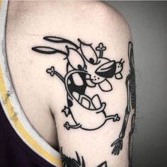 a man with a tattoo on his arm and shoulder that has an image of a cartoon character