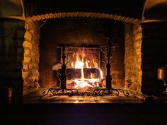 a fire burning in a fireplace with logs