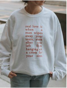 a woman wearing a white sweatshirt with words on it