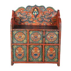 an orange and blue painted wooden cabinet with many different designs on the doors, drawers and shelves