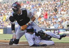 a baseball player sliding into home plate during a game