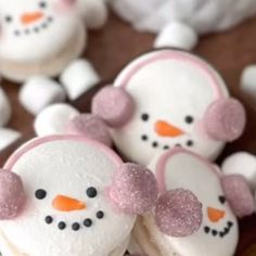 two snowmen made out of marshmallows sitting on top of a table