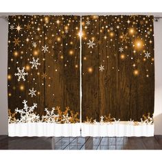 the curtains are decorated with lights and snowflakes