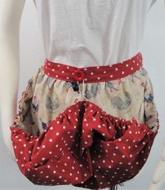 a mannequin wearing a red and white polka dot skirt with ruffles