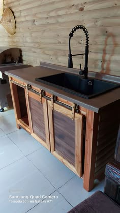 a kitchen with wooden cabinets and a black sink