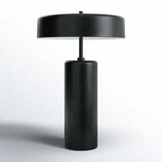 a black table lamp sitting on top of a white floor