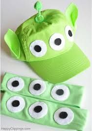 a green hat with googly eyes and eyeballs on it, next to a pair of headbands