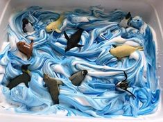 a cake with blue icing and small birds on it's top in a white box