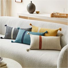 a white couch with colorful pillows on it