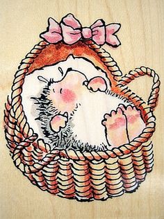 a drawing of a baby in a basket with a pink bow on it's head