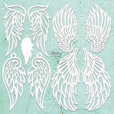 some white paper cut outs with wings on them